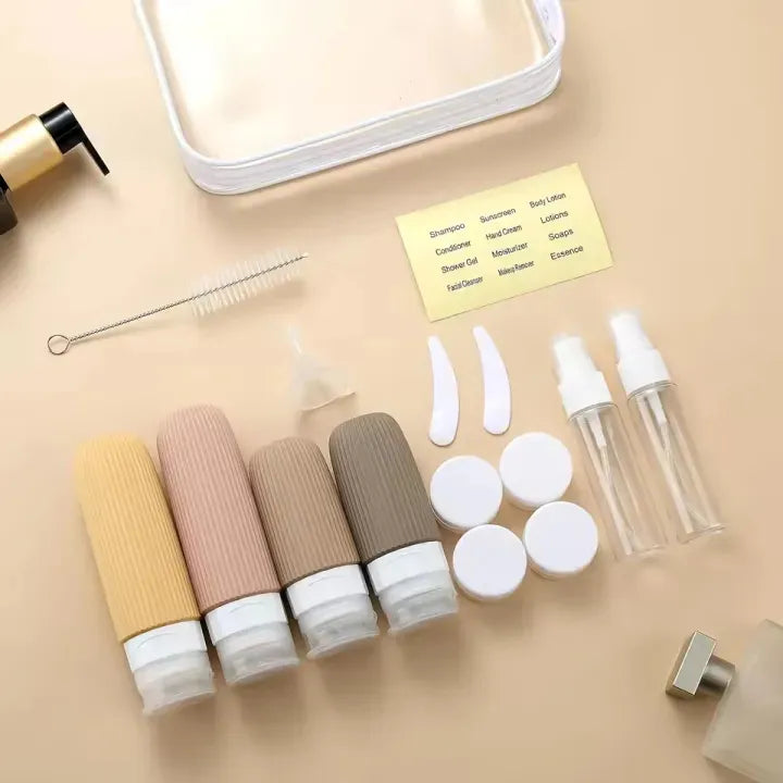 Set of cosmetic bottles and accessories on a beige surface