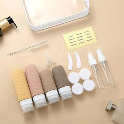 Set of cosmetic bottles and accessories on a beige surface
